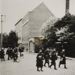 Grenadiers in het centrum van Rumbeke met conservenfabriek Optima op de achtergrond, 1940